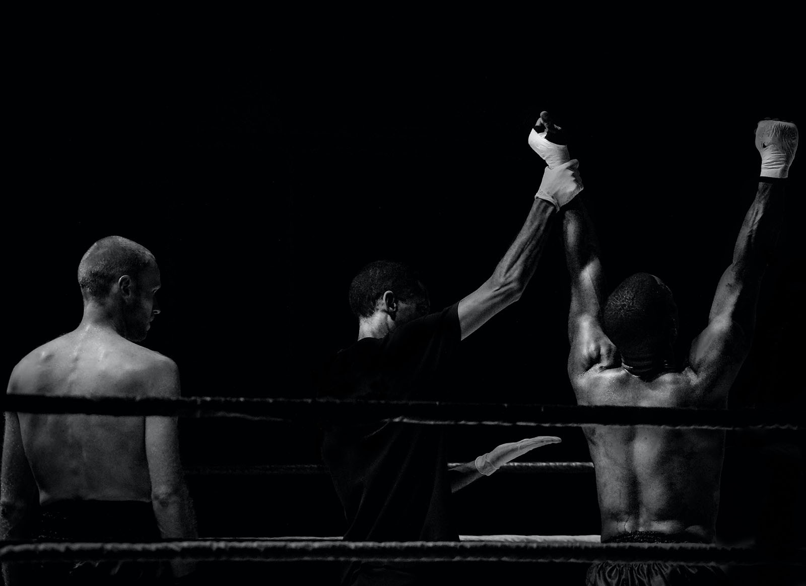 A victorious boxer celebrates the win.