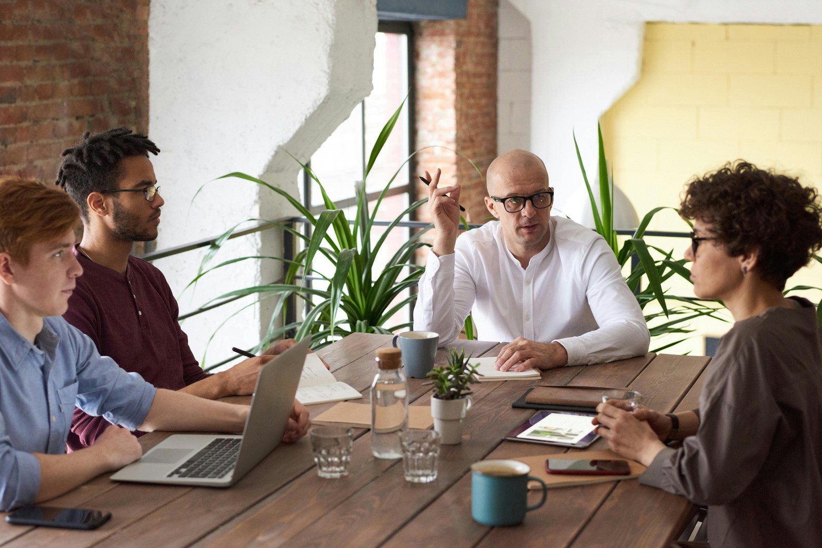 A creative team sitting in a relaxed meeting setting, discussing ideas and collaborating