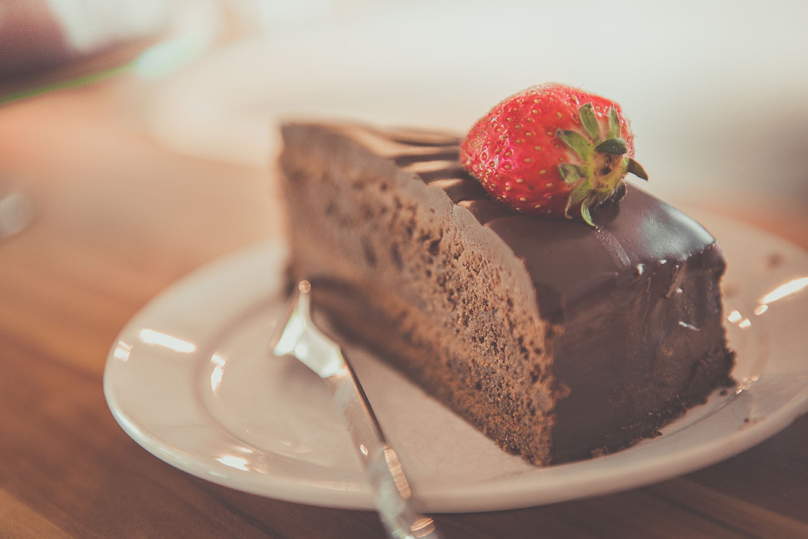 Chocolate cake with strawberry on top.