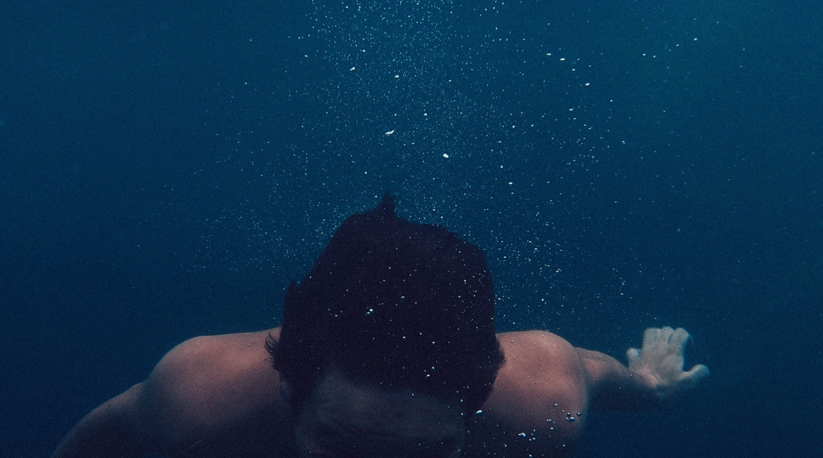 A man immersed in very deep water without breathing equipment.