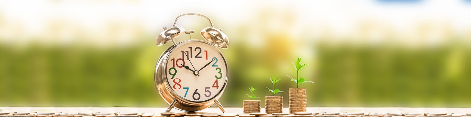 A clock and some coin piles sprouting vegetation - a metaphor for return on investment over time.