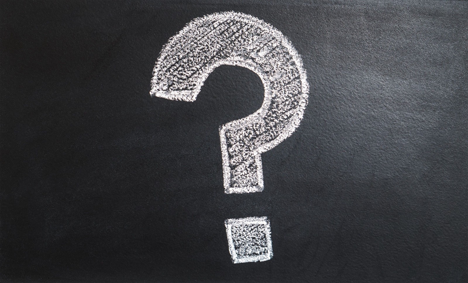 A question mark drawn in chalk on a blackboard.