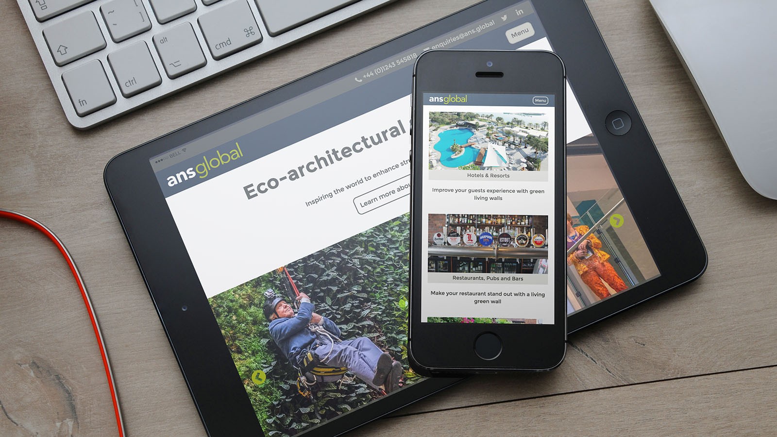 The ANS Global living wall applications page on an iPhone resting on an iPad.