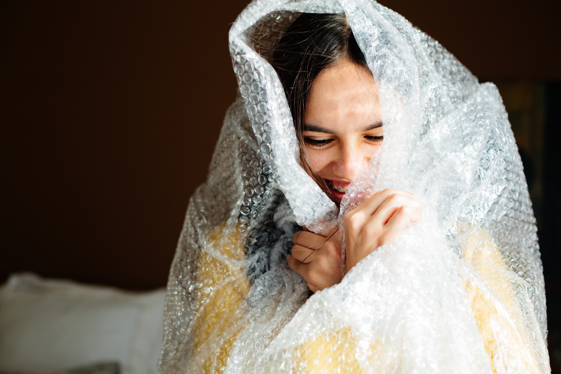 Lady smiling wrapped in bubble wrap