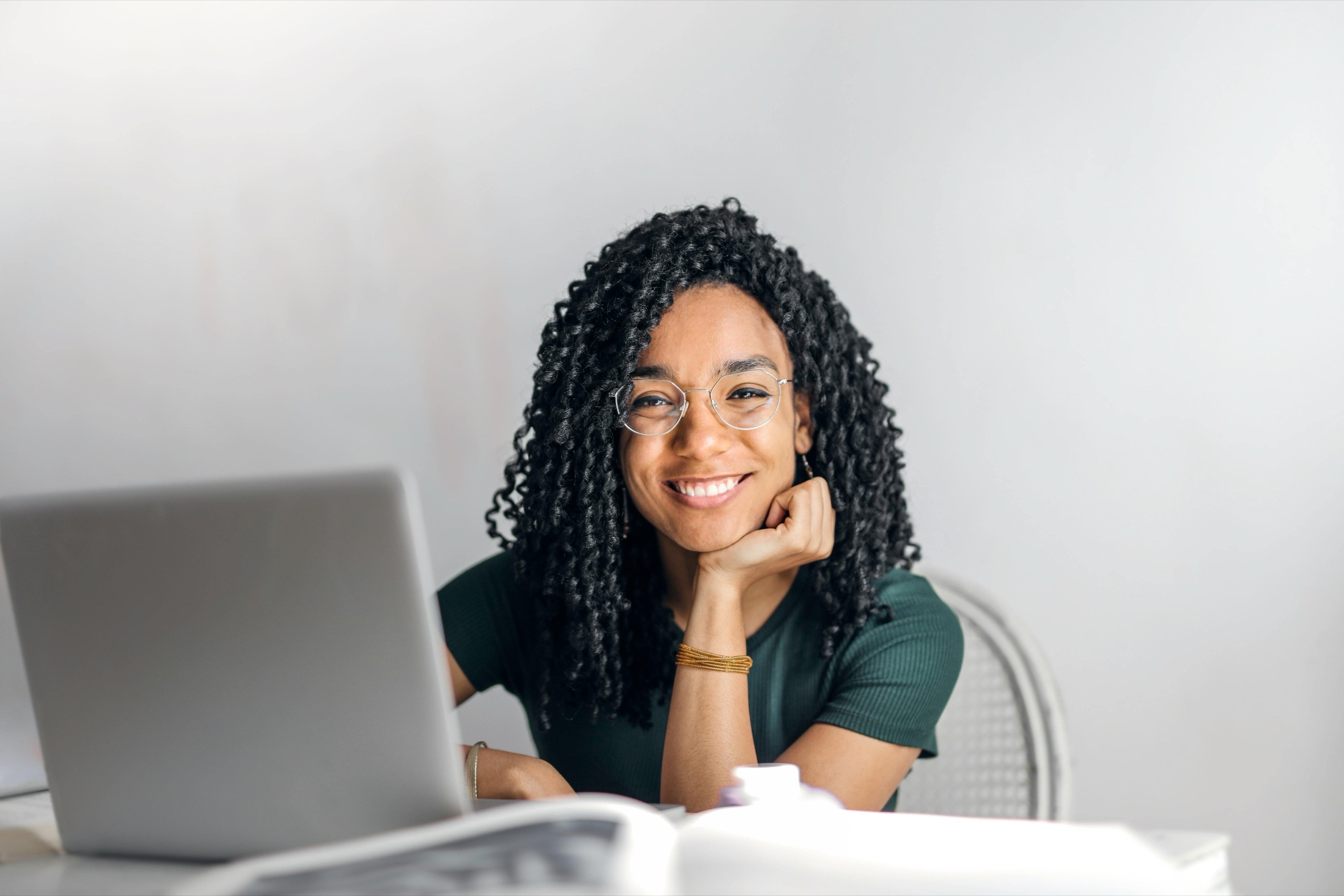 A woman smiling because she is happy she's found the content management software that works for her.