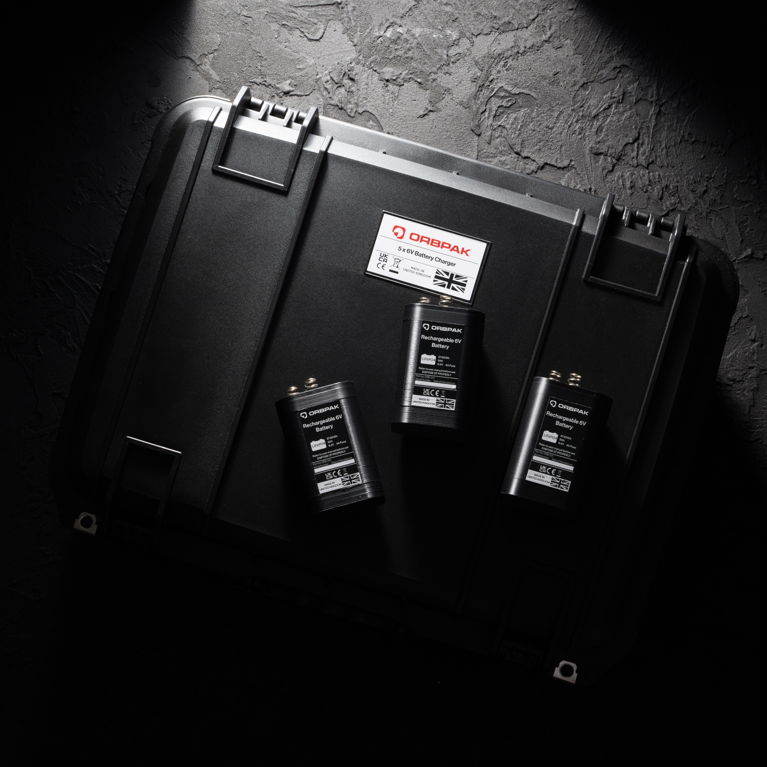 Three ORBPAK batteries sat on their charging case.