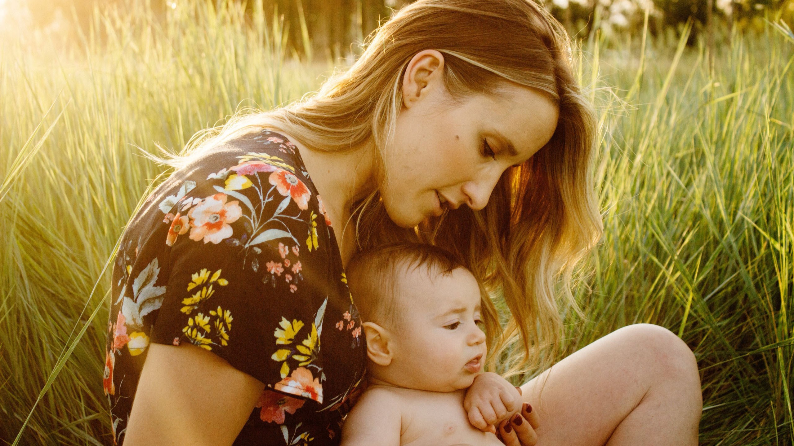 A mother and her baby outside on a warm sunny day.