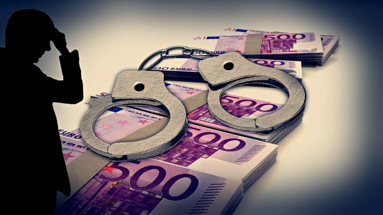 Bundles of Euro bank notes overlaid by handcuffs and a sinister silhouetted character on the left.